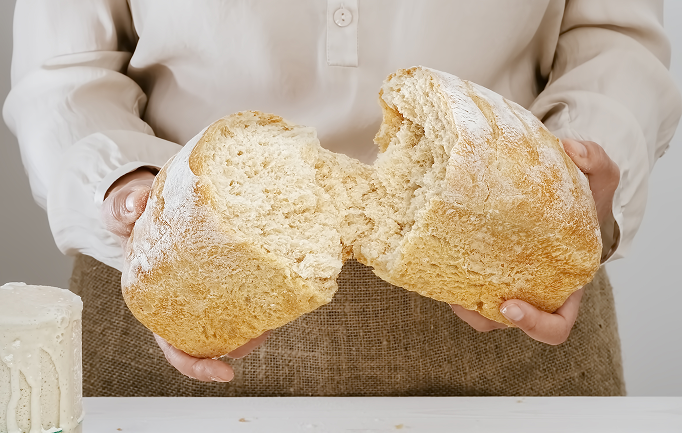 baker-holds-his-hands-freshly-baked-sourdough-bread 2